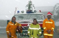 Mt Buller CFA captain Andrew Kelly, Carly Reudavey and Luke Corbett in the snow at Mt Buller on Christmas morning.
